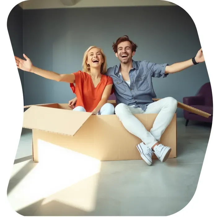 Two guys sitting on the floor of their apartment with Muval moving boxes